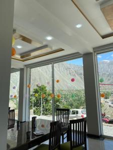 a dining room with a view of a mountain at Hill View Hotel in Astor