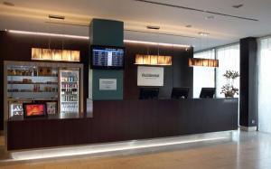 a bar in a hotel lobby with a counter at Occidental Praha Five in Prague