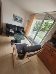 a living room with a couch and a window at Wohnung in Andermatt in Andermatt