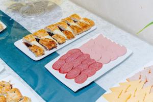 two plates of food on a table with sushi at Art Tashkent Hotel in Tashkent