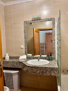 a bathroom with a sink and a mirror at Caniço Lodge in Caniço +31 photos