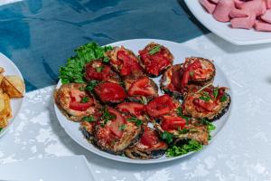 a plate of food with tomatoes and lettuce on a table at Art Tashkent Hotel in Tashkent +36 photos