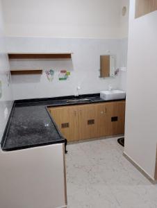 a kitchen with a sink and a counter top at RV Comforts in Perambalūr
