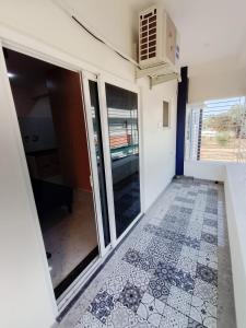 an empty room with a door and a tile floor at RV Comforts in Perambalūr +1 photo