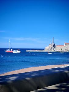a view of the ocean with boats in the water at Apartman Dona in Petrovac na Moru