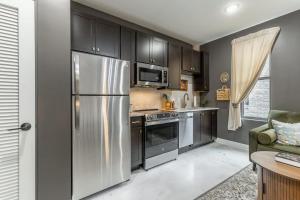 a kitchen with a stainless steel refrigerator and cabinets at Park Hotel Studio Suite 311 in Chattanooga