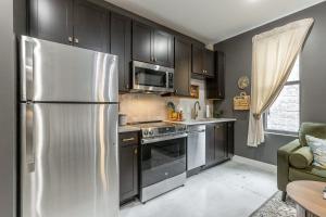 a kitchen with a stainless steel refrigerator and a microwave at Park Hotel Studio Suite 311 in Chattanooga