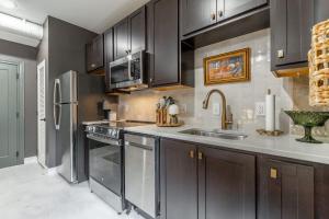 a kitchen with dark wood cabinets and stainless steel appliances at Park Hotel Studio Suite 311 in Chattanooga +25 photos