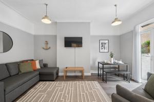 a living room with a couch and a table at Rockland Retreat - Near Crosby Beach & Liverpool in Waterloo