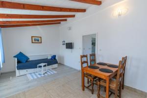 a living room with a table and a couch at Apartments Sime in Lopar