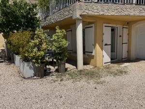 a house with two trees in front of it at bas de Villa "Le Tiste" in Valensole