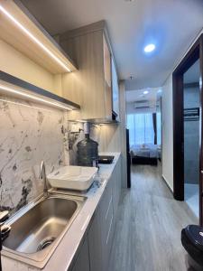 a kitchen with a sink and a counter top at P4 Type Studio Apt Swimming Pool View Batam Centre in Batam Center