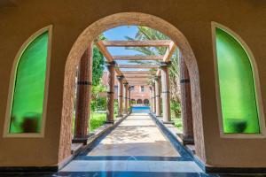an arched hallway of a house with an archway at Tiznit Hotel in Tiznit