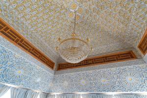 a ceiling with a chandelier in a room at Tiznit Hotel in Tiznit