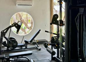 a gym with several exercise bikes and a mirror at Bali Atins in Atins