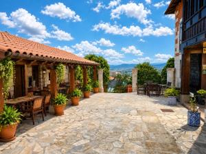 a patio with a table and chairs and a view at Posada Campo in Suances