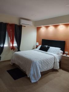 a bedroom with a large bed and a window at HcHOME in Algeciras