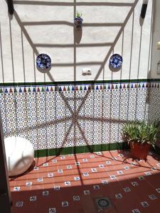 a room with a tile floor with blue plates on the wall at HcHOME in Algeciras