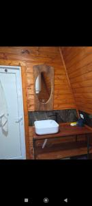a bathroom with a sink and a wooden wall at Cottage Irko in Tvebishi +6 photos