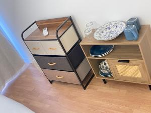 a wooden cabinet with a mirror and plates on it at Aparthotel New Palmarium in Amélie-les-Bains-Palalda