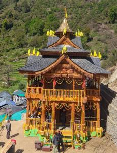 a large building with people in it on a mountain at Dholadhar Hotel & Restaurant in Barot 
