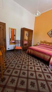 a bedroom with a bed and a table and a mirror at Albergo Pensione Bartoli in Castiglioncello +84 photos