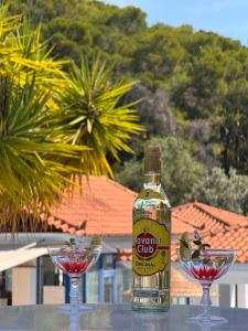 a bottle of wine and two glasses on a table at Vassilis Studios in Poros