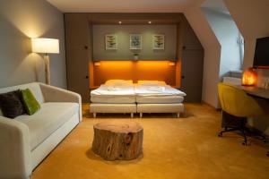a room with a bed and a table with a tree stump at Penzion Nový Rybník in Obořiště +43 photos
