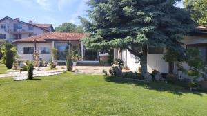 a house with a tree in the yard at Villa Toni in Varna City +9 photos