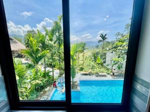 a window with a view of a swimming pool at Puluong Aroma in Lũng Tiềm