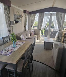 a living room with a table and a couch at 14B Medina Rise Ferry Offers Available in Porchfield