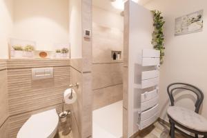 a small bathroom with a toilet and a stool at U Scogliu Escale De Rêve in Poggio-dʼOletta +33 photos