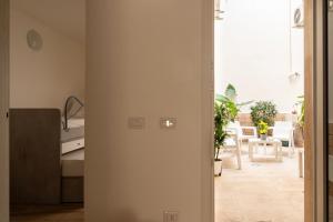 a hallway with a bed and a room with a table at Sarmalia 32 a pochi passi dal centro di Nardò in Nardò +12 photos