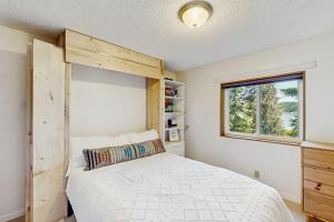 a bedroom with a bed and a window at Hill House in Belfair