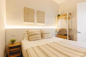 a bedroom with a bed with two pillows on it at Bravissimo Nou del Teatre, with panoramic views in Girona