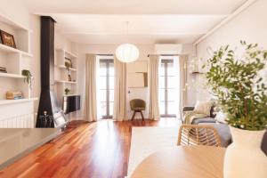 a living room with a couch and a table at Bravissimo Nou del Teatre, with panoramic views in Girona