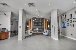 a lobby with a table and chairs and a television at Four Points by Sheraton Oakville in Oakville
