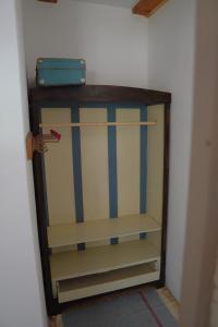 a cabinet with a suitcase sitting on top of it at Bed&More Almáspuszta in Jestice