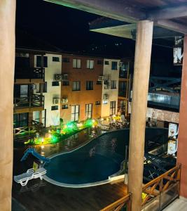 a view of a swimming pool at night at Vila Atlântida BEACH FLAT 311B in Luis Correia