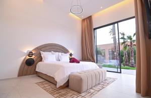 a bedroom with a large bed and a large window at The Oasis Marakech in Marrakesh +151 photos