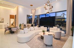 a living room with white furniture and a large window at The Oasis Marakech in Marrakesh