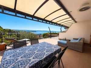 a patio with a table and a view of the ocean at Apartment Vrenjak in Portorož