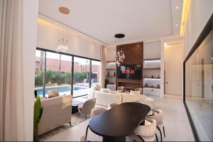 a living room with white furniture and a pool at The Oasis Marakech in Marrakesh