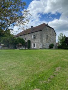 an old stone house with a large grass field at Château de Savigny - Suite Eau in Savigny