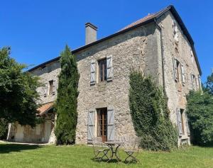 an old stone building with a picnic table in front of it at Château de Savigny - Suite Eau in Savigny