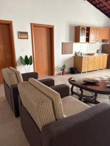 a living room with two chairs and a table at Guest House by Roni in Durrës