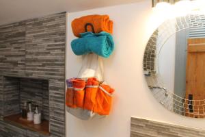 a bunch of towels hanging on a wall next to a mirror at Number Eleven Unique Boutique in Great Gransden +82 photos