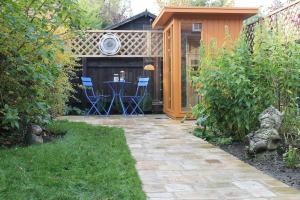 a patio with a table and chairs in a garden at Number Eleven Unique Boutique in Great Gransden