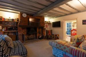 a living room with a couch and a fireplace at Number Eleven Unique Boutique in Great Gransden