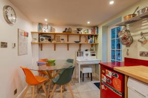 a kitchen with a table and chairs and a desk at Number Eleven Unique Boutique in Great Gransden